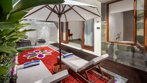A spa area with a wooden deck, a white umbrella, and a flower-patterned floor. - Jenna Villa by GenuineHost (Ubud)