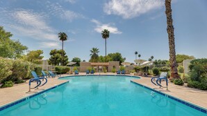 A clear blue pool with lounge chairs and palm trees. - 2 Mi to Old Town & Fashion Sq: Townhome w/ Pools (Scottsdale)
