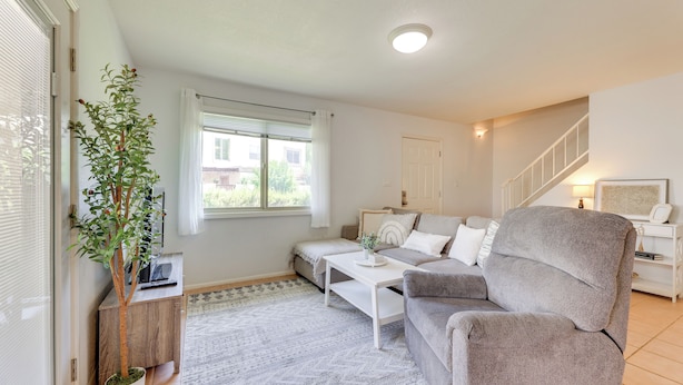 A modern living room with a sofa, coffee table, and a potted plant. - 2 Mi to Old Town & Fashion Sq: Townhome w/ Pools (Scottsdale)