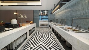 A modern kitchen with a geometric patterned floor, stainless steel appliances, and a blue-tiled backsplash. - Yizhi Hotel Shamian Pearl River Night Cruise-Canton Fair free shuttle bus included free Breakfast&Gym&Laundry&free coffee allday (Guangzhou)