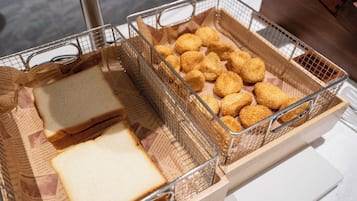 A tray with bread and croquettes.