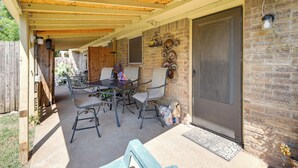 An outdoor patio with a covered seating area, a brick wall, and a door. - 4 Blocks to AT&T Stadium: 'Entertainment Central!' (Arlington)
