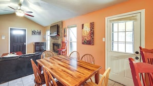 A dining area with a wooden table and chairs, a fireplace, and a door with a window. - 4 Blocks to AT&T Stadium: 'Entertainment Central!' (Arlington)