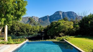 A swimming pool with a view of mountains in the background.