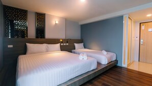 A hotel room with two beds, wooden headboards, and a modern design. - One Budget Hotel Chiangrai Soi Sawan (Chiang Rai)