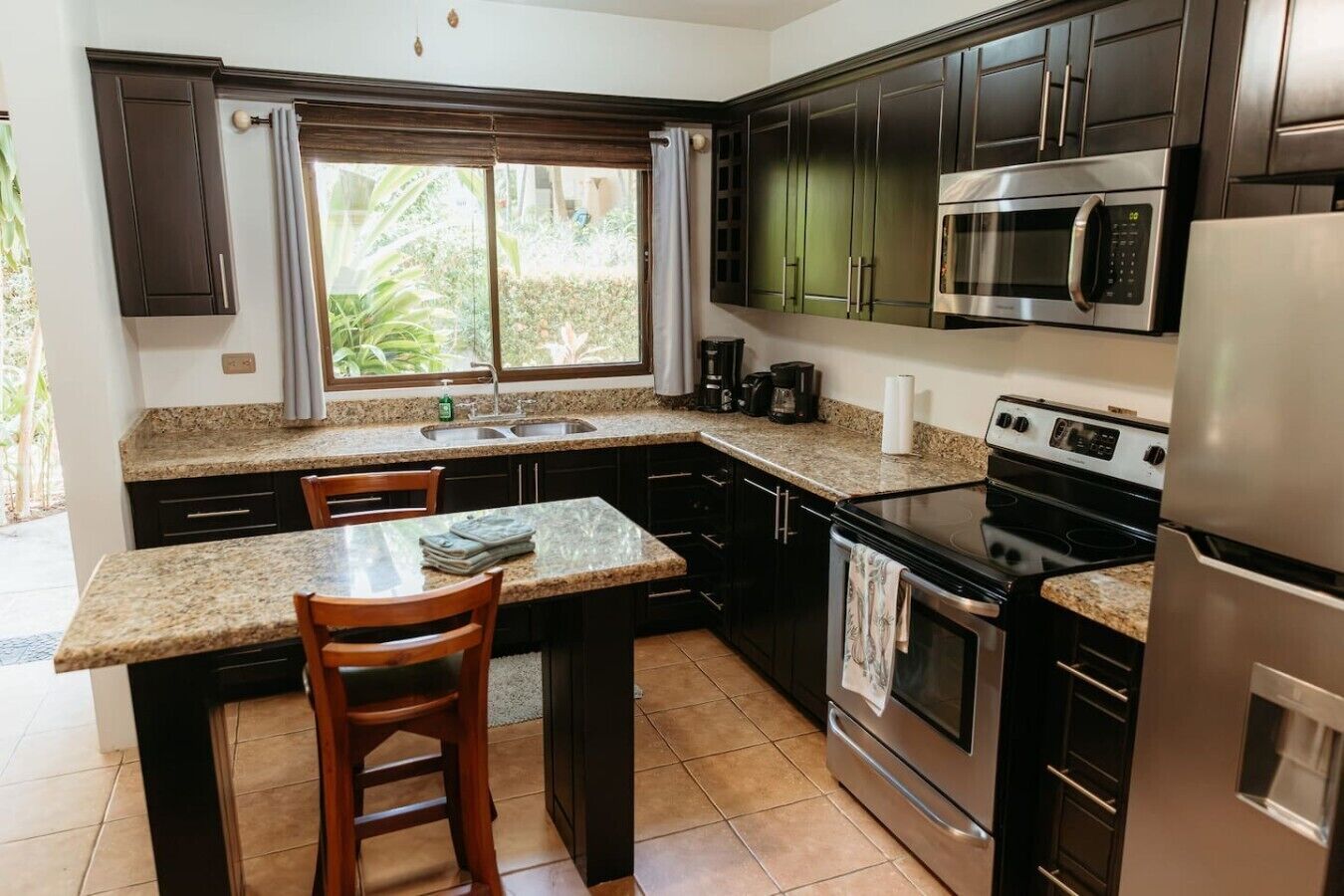 Fridge, microwave, coffee/tea maker, cookware/dishes/utensils