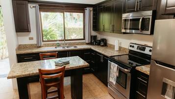 Fridge, microwave, coffee/tea maker, cookware/dishes/utensils