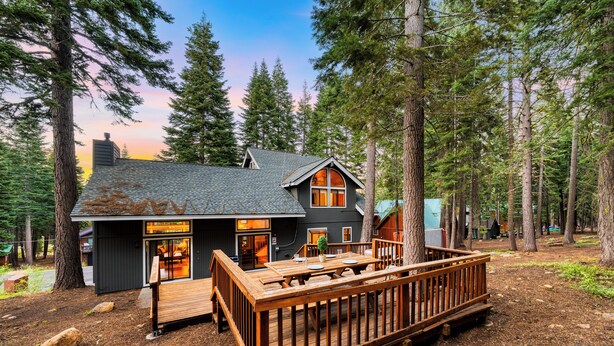 A cabin with a deck, surrounded by trees. - Forest Views, Hot Tub & Tahoe Donner Access | Alpenglow Chalet by AvantStay (Truckee)