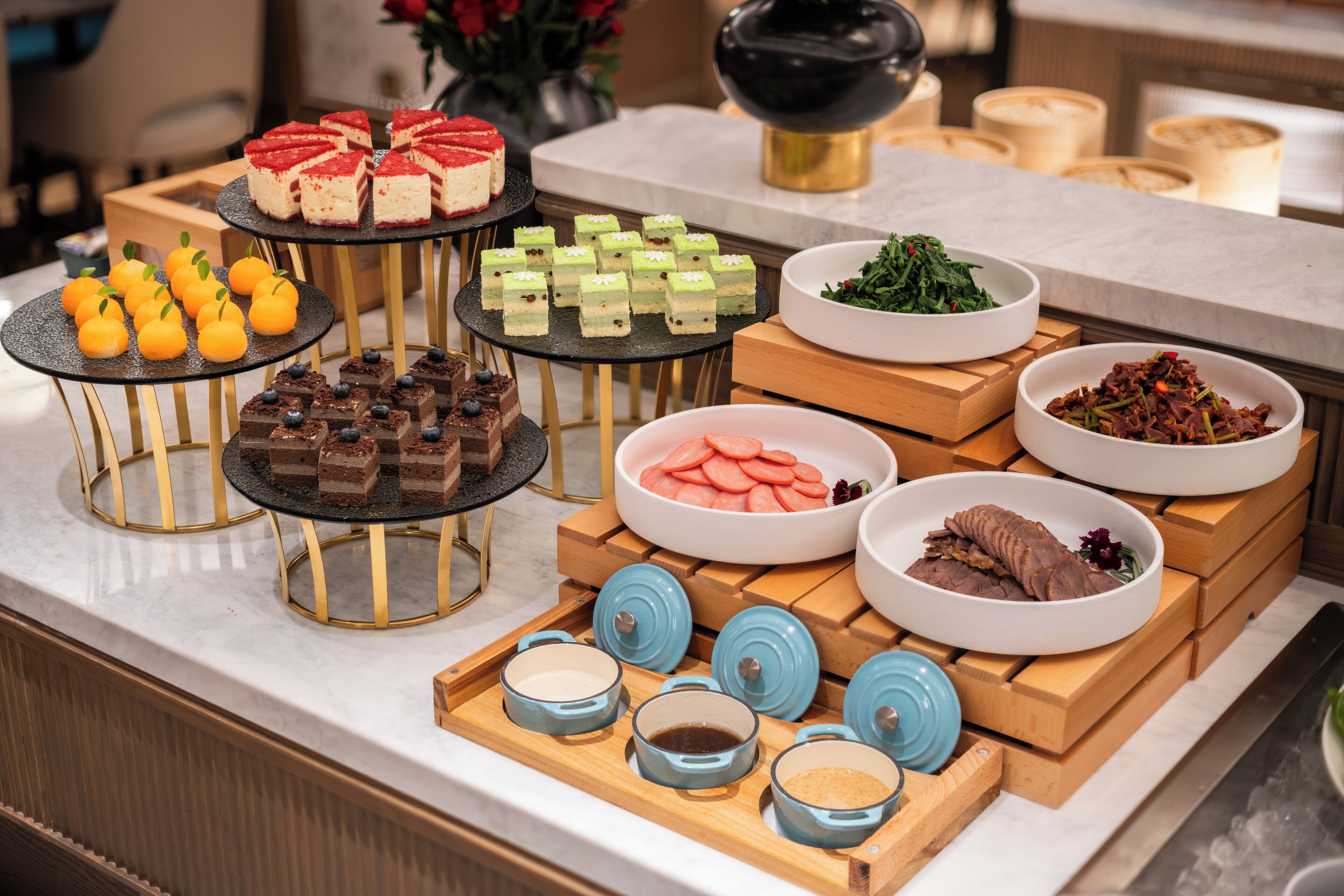 A buffet table with various food items and condiments.