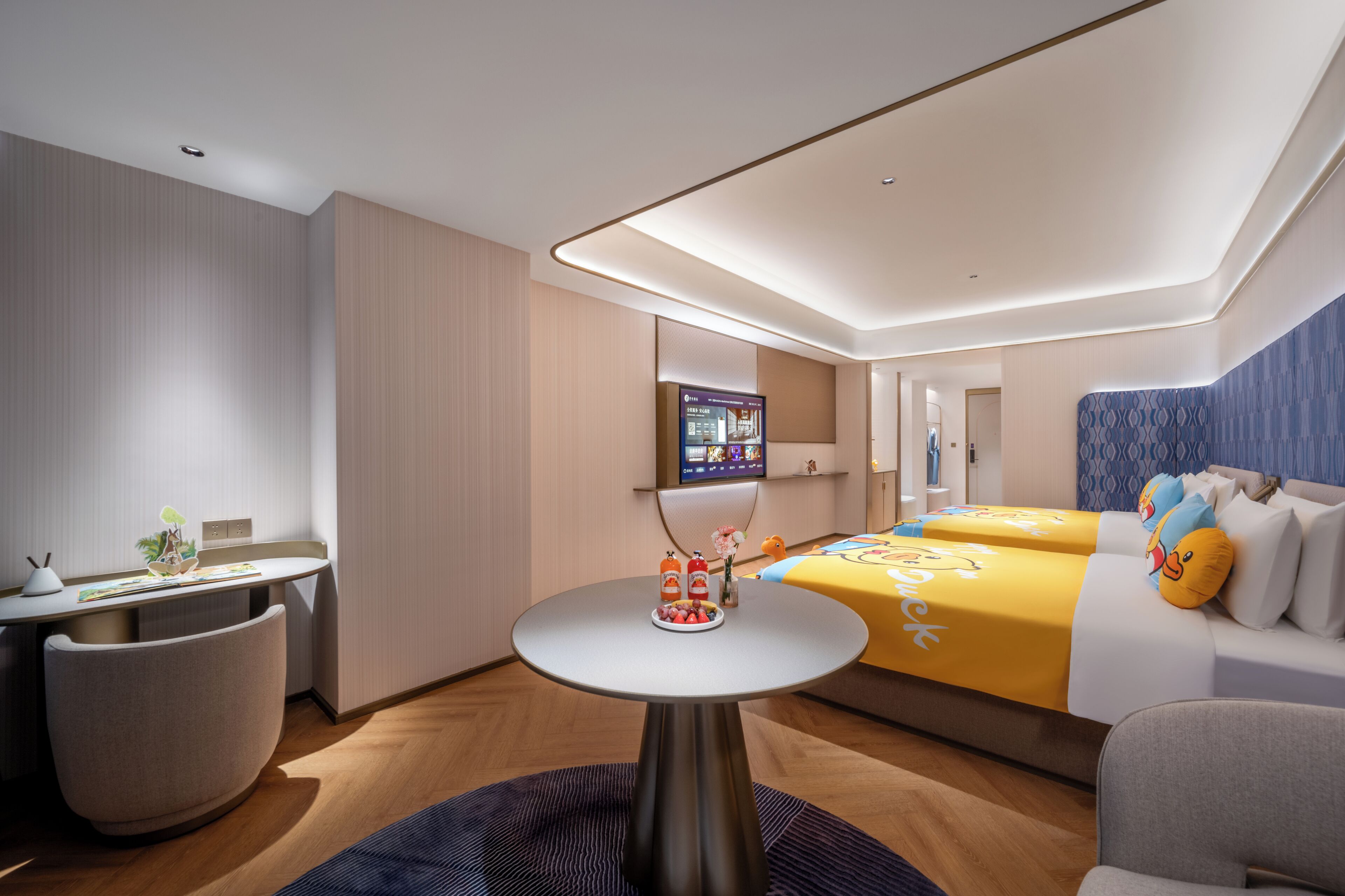 A modern hotel room with a bed, bedside table, and a TV mounted on the wall.