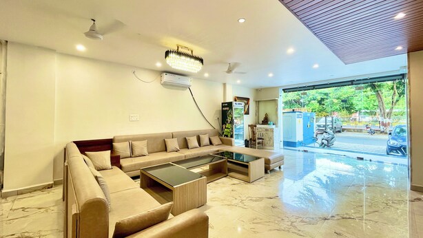 A modern living room with a sofa, coffee table, and a ceiling fan.