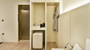 A modern bathroom with a walk-in shower, a built-in sink, and a towel rack. - SongDODenbastaHotel (Busan)