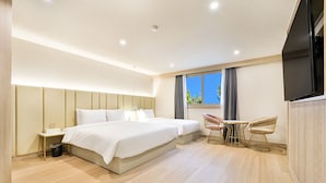 A modern hotel room with a large bed, bedside tables, a TV, and a window with curtains. - SongDODenbastaHotel (Busan)