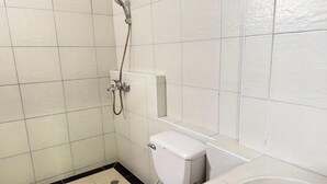 A small, clean bathroom with white tiles, a toilet, a shower, and a sink. - Value Twin Stay | Cozy & Convenient Retreat (Chiang Mai)