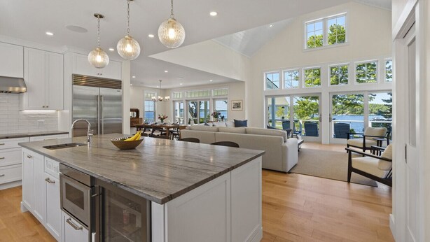 A spacious kitchen with a large island, modern appliances, and pendant lighting. - Ocean Point Boothbay Luxury Home|5BR |4.5BA|Sleeps 12 (Boothbay)