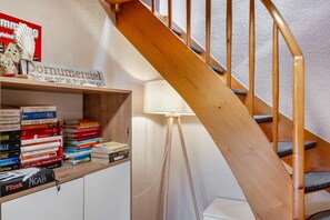 Eine Treppe mit Holzgeländern und einem Bücherregal voller Bücher.