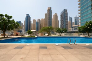 A swimming pool with a city skyline in the background.