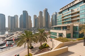 A modern hotel with a view of a marina and high-rise buildings.