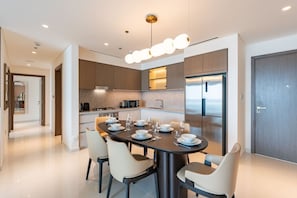 A modern kitchen with a dining area set for six.