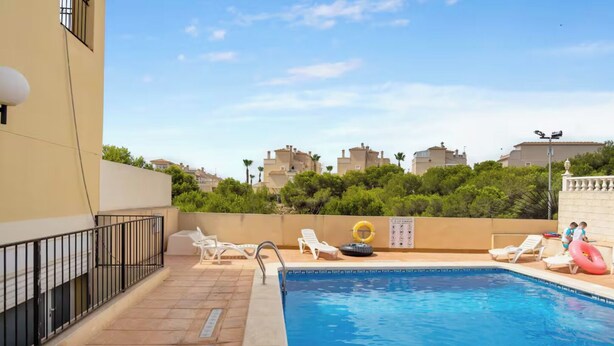 A rooftop pool area with lounge chairs and a lifebuoy. - Beautiful 3-bedroom home in Playa Flamenca, Alicante. Spain. (Orihuela)