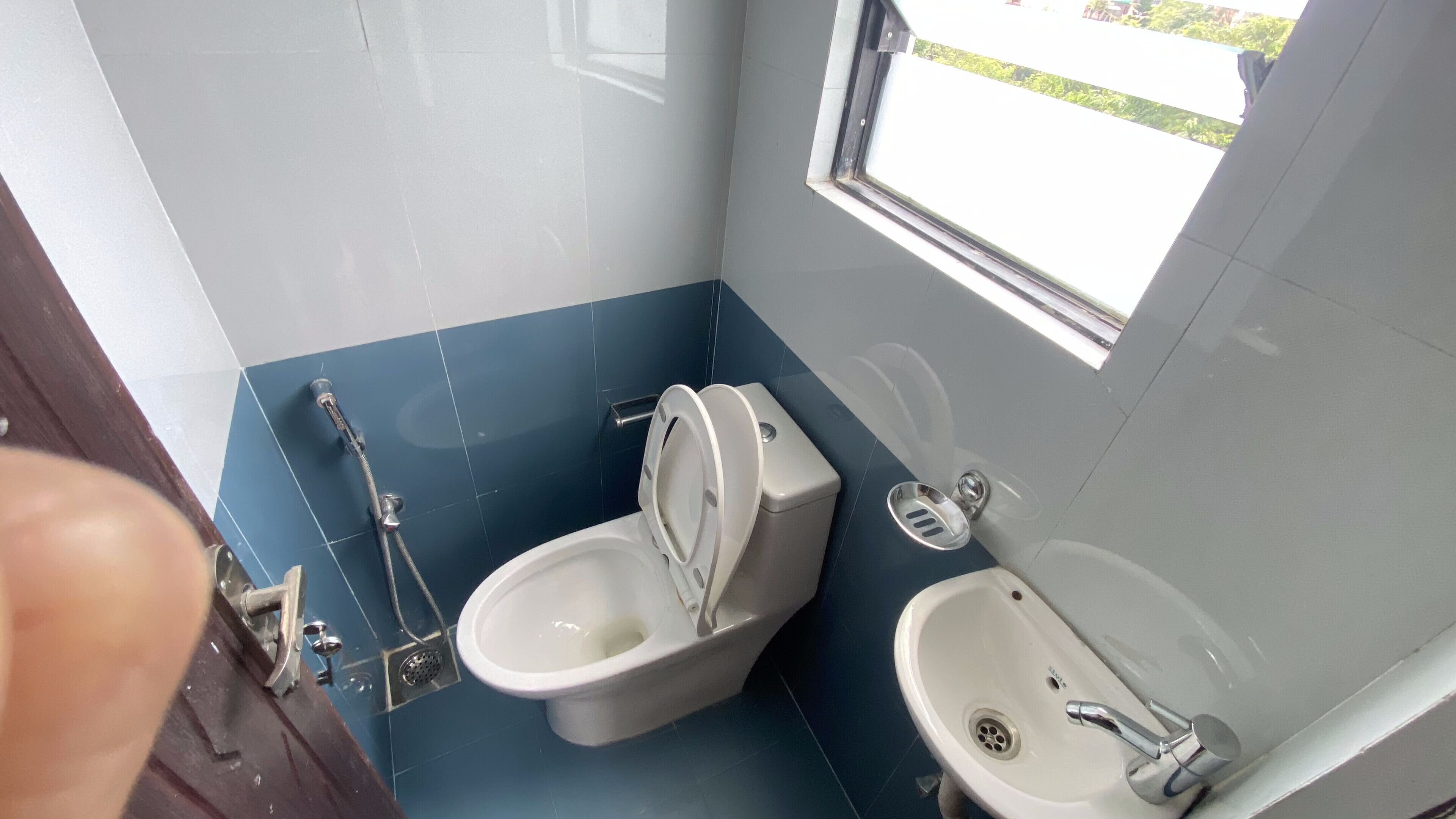 A small bathroom with a toilet, bidet, and sink.