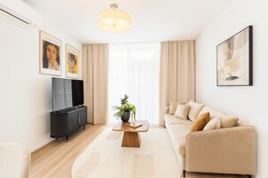 Deluxe Apartment, 1 Bedroom, City View | Living room | 55-cm LED TV with digital channels
