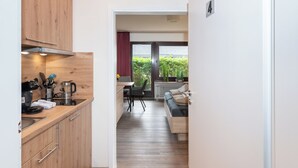 A modern kitchen with wooden cabinets and a dining area with a table and chairs.