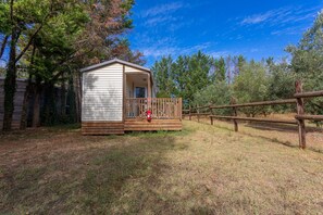 A small cabin with a wooden deck and a fire extinguisher.