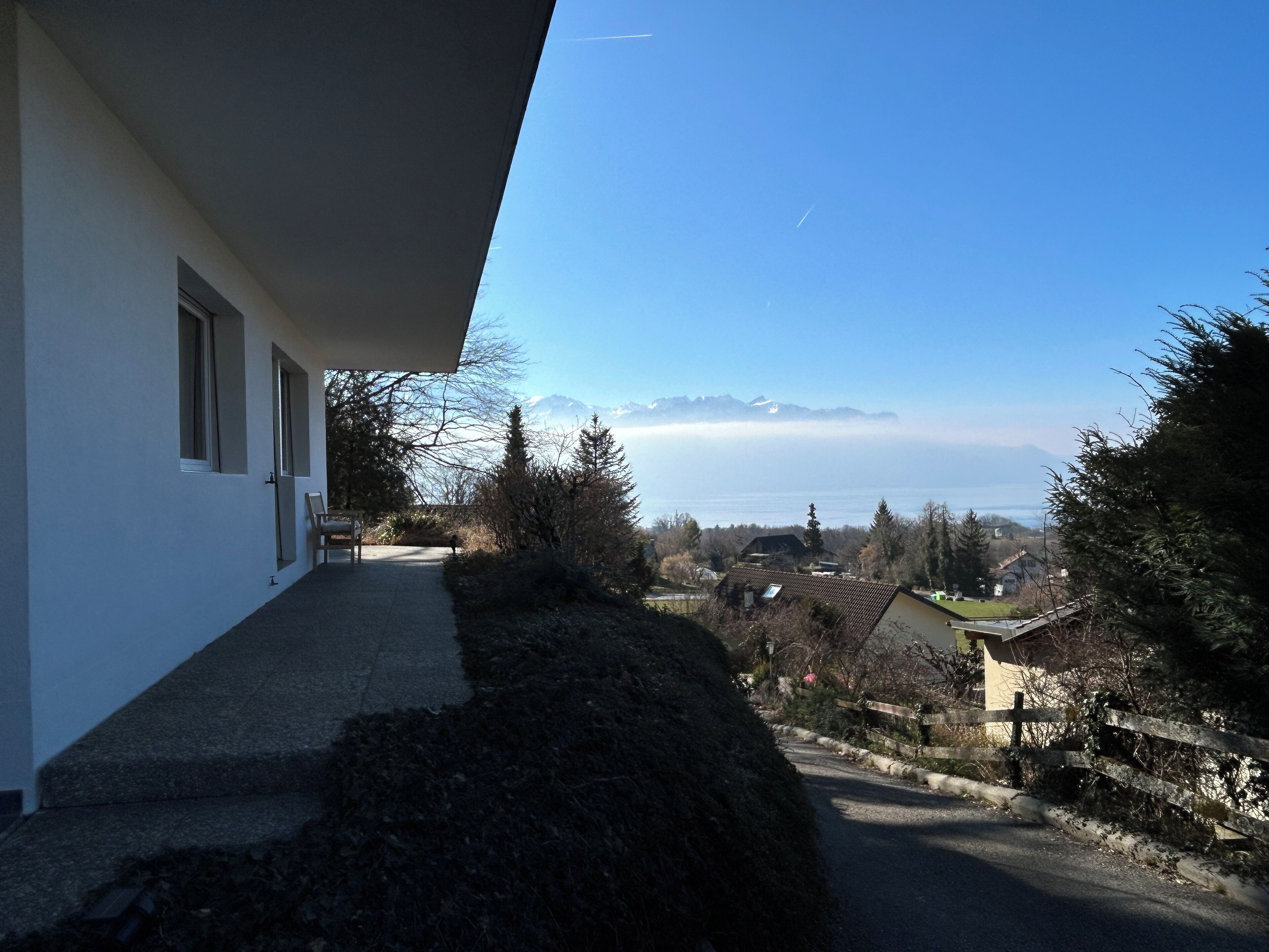 A residential property with a view of mountains and a lake.