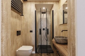 A modern bathroom with a glass-enclosed shower, a wooden vanity with a large basin, and a toilet. - Torrigiani Charming Apartment (Firenze)
