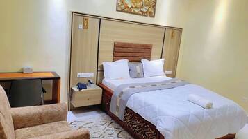 Deluxe Room, City View | In-room safe, desk, laptop workspace, soundproofing