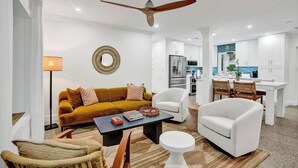 A modern living room with a sofa, armchairs, a coffee table, and a dining area with a table and chairs. - Poolside Palms Villa 🌴 Resort-Style Pool | Near Beach 🏖️ (Fort Lauderdale)