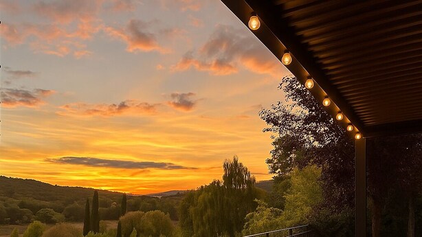 A balcony with a view of a sunset over a hilly landscape. - Stunning Loft nestled in the Tuscan countryside 15 minutes walk from the center. (Toscana)
