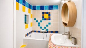 A bathroom with a bathtub, a sink, and a wooden medicine cabinet. - 💙Studio Saint Victor, next to Notre Dame 🤍, lovely decorated, very quiet ❤️ (Paris)