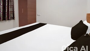 Ein Hotelzimmer mit einem Bett, einem Schrank und einem Vorhang.