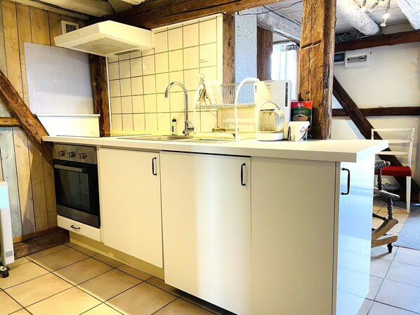 A kitchen with a built-in oven, a sink, and a coffee maker. - 4 Person Holiday Home in Uddevalla (Uddevalla)