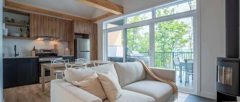 A modern living space with a kitchen, a sofa, and a fireplace.