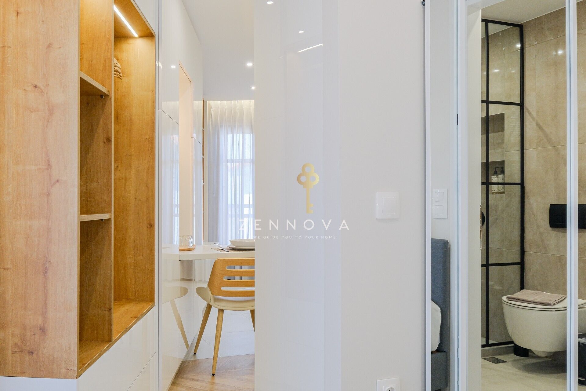 A modern bathroom with a shower, toilet, and a glass partition.