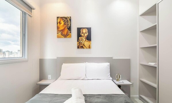 A modern hotel room with a bed, a nightstand, a bedside table, and a large window. There are two paintings on the wall above the bed. - Apartment With Barbecue 600m Beach Etp1002 (Porto Belo)