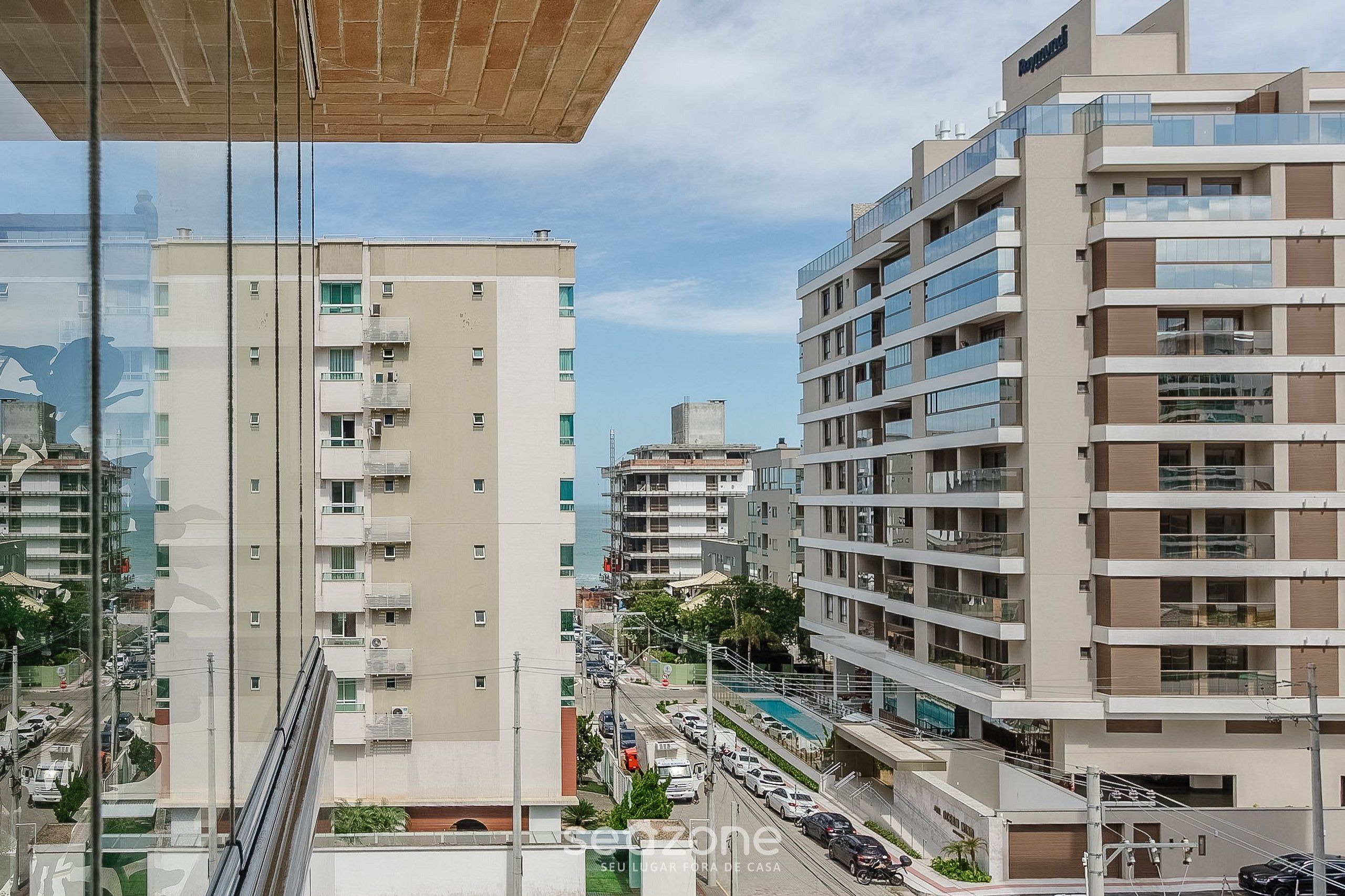 Un edificio moderno de varios pisos con balcones y vista a la calle.