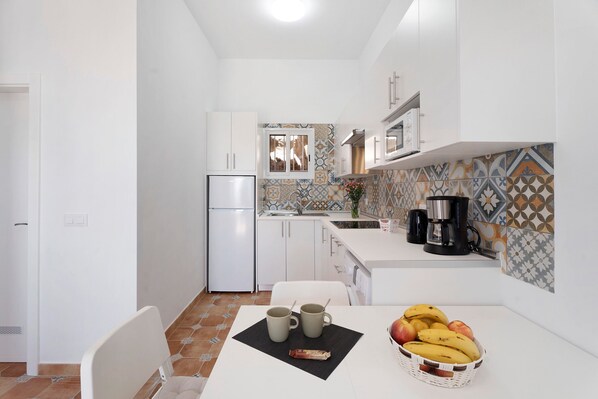 Fridge, microwave, stovetop, coffee/tea maker