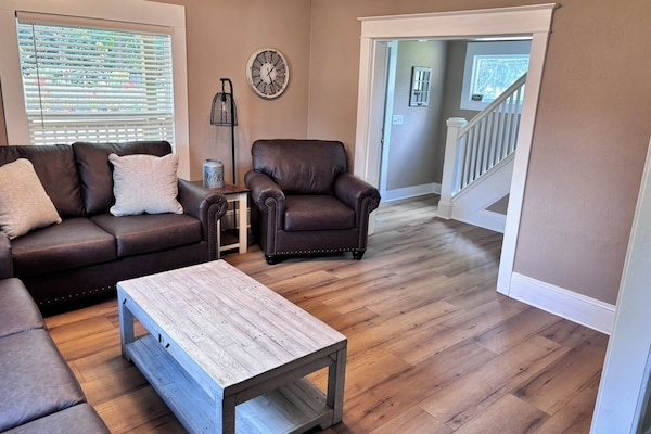 Family room, to the right of the front door. Large couch is a sofa-bed