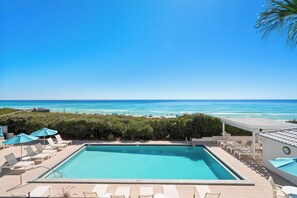 Una piscina con vista a la playa y al océano.