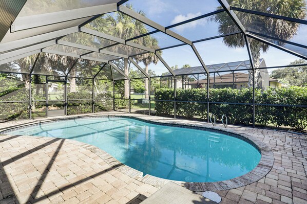 A swimming pool with a covered area, surrounded by brick flooring and greenery. - Palm Coast Escape w/ Outdoor Oasis: 6 Mi to Shore! (Palm Coast)