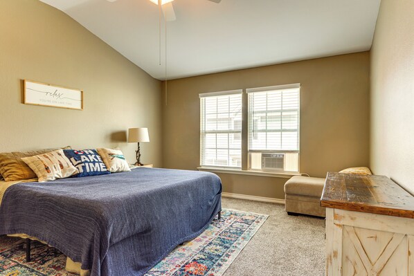 A bedroom with a bed, a window, a lamp, and a dresser. - Poolside Bliss & Lake Fun: Monkey Island Retreat! (Afton)
