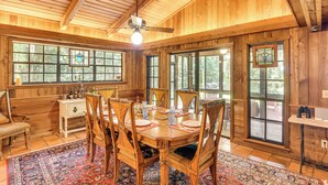 A wooden dining room with a large table, chairs, and a ceiling fan. - Little Lake George Hideaway w/ Furnished Boathouse (Welaka)