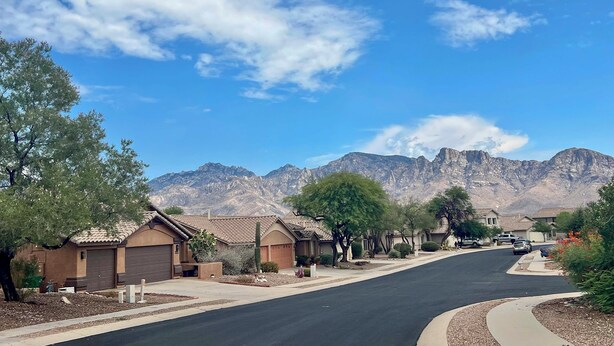 A residential street with houses, a clear sky, and mountains in the background. - Heated Pool & Spa: Catalina Mtn-view Home! (Oro Valley)