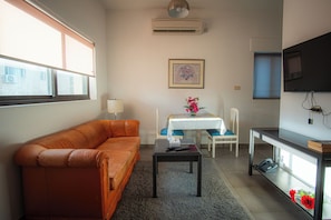 Deluxe Suite, Garden View | In-room safe, laptop workspace, soundproofing, iron/ironing board