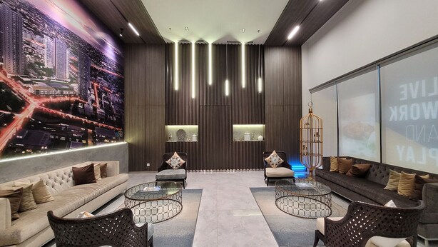 A modern living room with a large cityscape mural, dark wood paneling, and a seating area with sofas and coffee tables. - Palam Mansion Citra Plaza Nagoya (Batam)