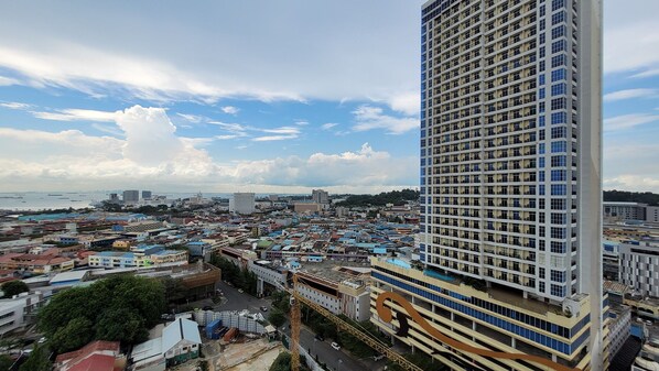 A high-rise building with a modern design, featuring a large number of windows and balconies.